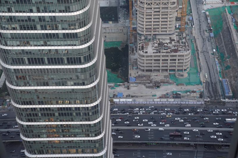 &copy; Reuters. FILE PHOTO: Cars drive past construction sites in Beijing's central business area, China November 21, 2018. Picture taken November 21, 2018. REUTERS/Jason Lee