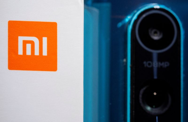 &copy; Reuters. FILE PHOTO: Xiaomi logo is seen next to a smartphone of the same brand in this illustration taken September 28, 2021. REUTERS/Dado Ruvic/Illustration