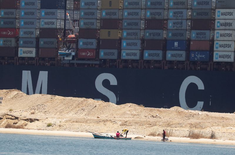 &copy; Reuters. FILE PHOTO: An MSC container ship passes through the Suez Canal near fishermen and their boat, in Ismailia, Egypt July 7, 2021. REUTERS/Amr Abdallah Dalsh