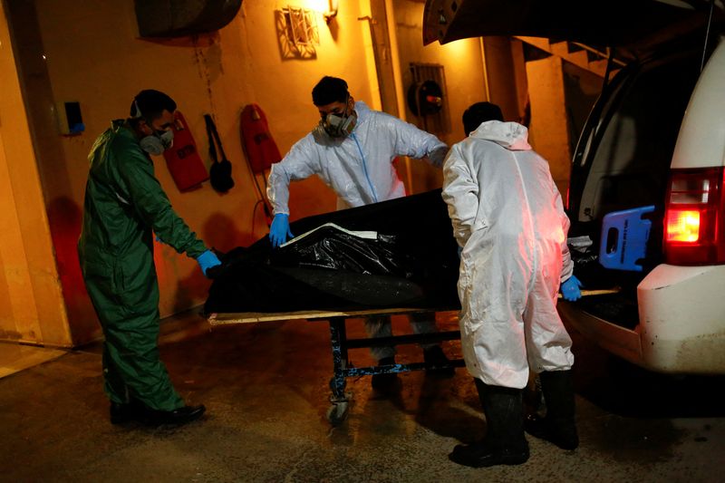 &copy; Reuters. Employees of the Rios funeral home move the body of a person, who died from the coronavirus disease (COVID-19), into the facility in Ciudad Juarez, Mexico January 5, 2022.  REUTERS/Jose Luis Gonzalez