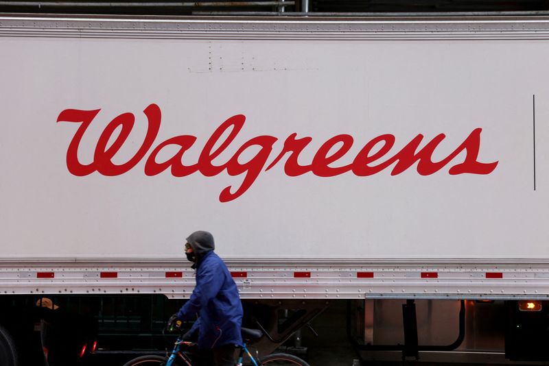 &copy; Reuters. FILE PHOTO: A person rides past a Walgreens truck, owned by the Walgreens Boots Alliance, Inc., in Manhattan, New York City, U.S., November 26, 2021. REUTERS/Andrew Kelly