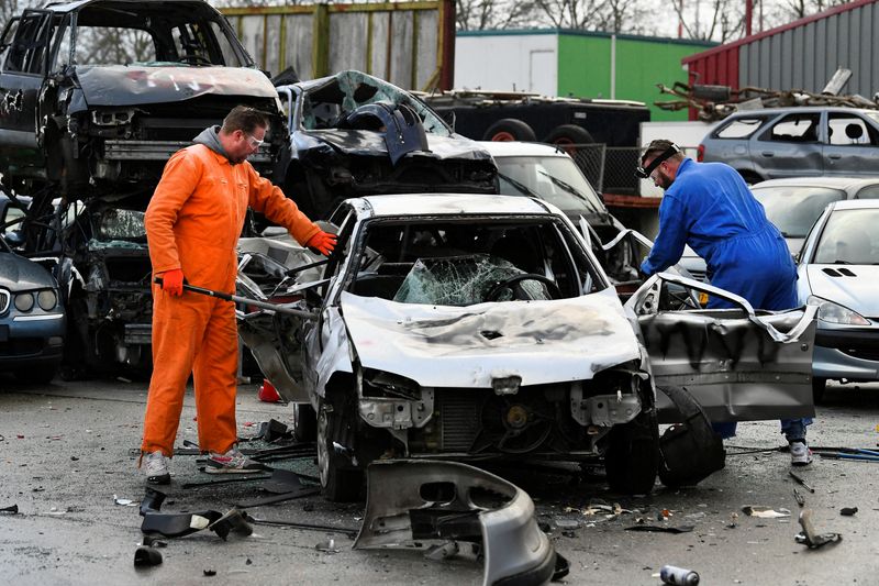 &copy; Reuters. Twin brothers Steven and Brian Krijger use hammers to scrap a car to express their frustration as the Netherlands undergoes another lockdown in Vijfhuizen, Netherlands January 5, 2022.  REUTERS/Piroschka van de Wouw