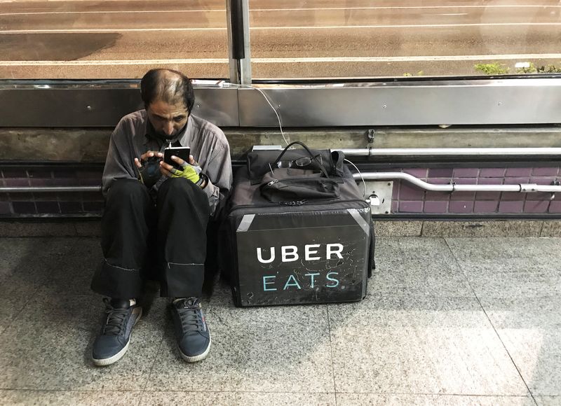 &copy; Reuters. FILE PHOTO: An Uber Eats worker checks his mobile phone at Paulista Avenue in Sao Paulo, Brazil, September 19, 2018. REUTERS/Nacho Doce