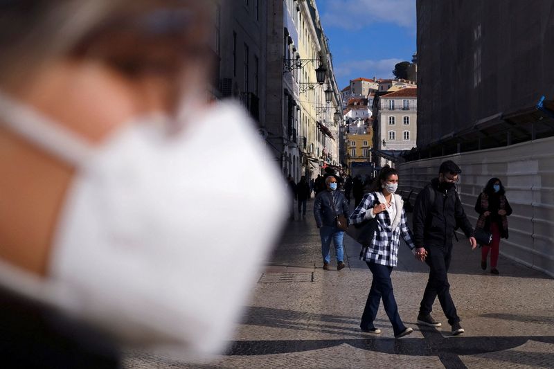 &copy; Reuters. 新型コロナウイルスのオミクロン変異株の拡大に伴い、欧州で感染者数の急増が続く中、各国の対応に格差が出てきた。リスボンで２０２１年１２月撮影（２０２２年　ロイター/Pedro Nunes）