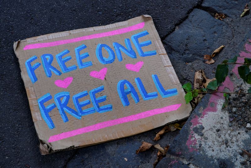 &copy; Reuters. A 'Free one, free all' sign lays on the ground outside the Park Hotel, where Serbian tennis player Novak Djokovic is believed to be held while he stays in Australia, in Melbourne, Australia, January 7, 2022. REUTERS/Sandra Sanders