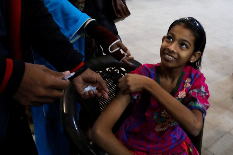 &copy; Reuters. Karachi, aux prises avec une cinquième vague de COVID-19, a lancé une campagne de porte-à-porte pour vacciner les femmes, qui bénéficient d'une couverture vaccinale bien moindre que celle des hommes. /Photo prise le 6 janvier 2022/REUTERS/Akhtar Soom