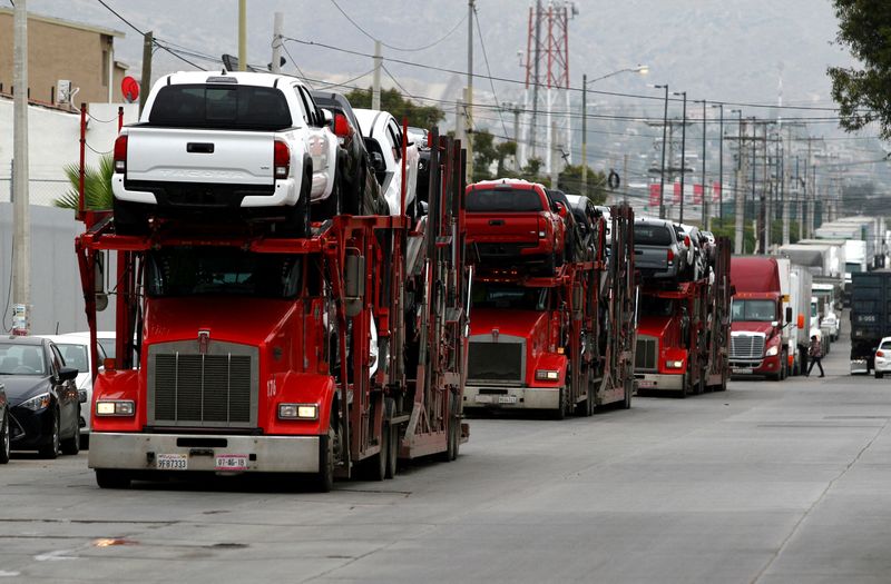 &copy; Reuters. FILE PHOTO: A carrier trailer transports Toyota cars for delivery while queuing at the border customs control to cross into the U.S., at the Otay border crossing in Tijuana, Mexico May 31, 2019. REUTERS/Jorge Duenes/File Photo