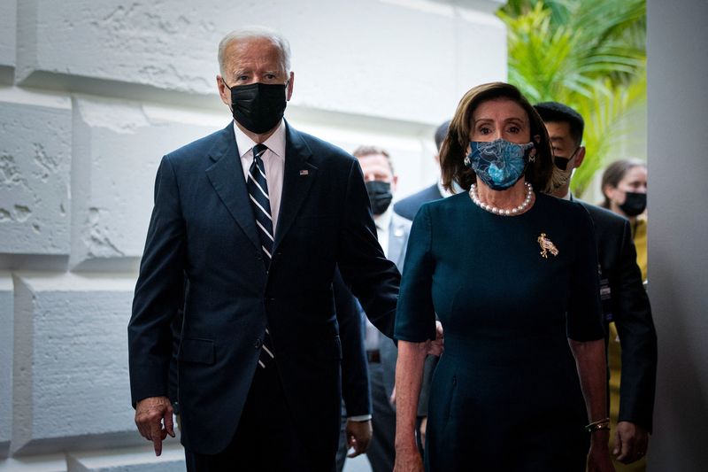 &copy; Reuters. FILE PHOTO: U.S. President Joe Biden is escorted by House Speaker Nancy Pelosi (D-CA) as he departs following speaking to the House Democratic Caucus to provide an update about the Build Back Better agenda and the bipartisan infrastructure deal at the U.S