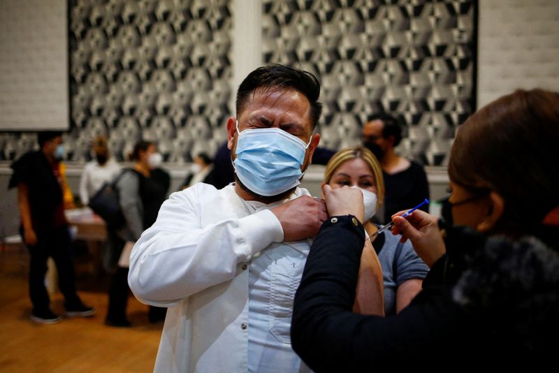 &copy; Reuters. أحد العاملين في القطاع الصحي يتلقى جرعة معززة من لقاح واق من الإصابة بفيروس كورونا في سيوداد خواريز بالمكسيك يوم السادس من سبتمبر أيلول 2022. 