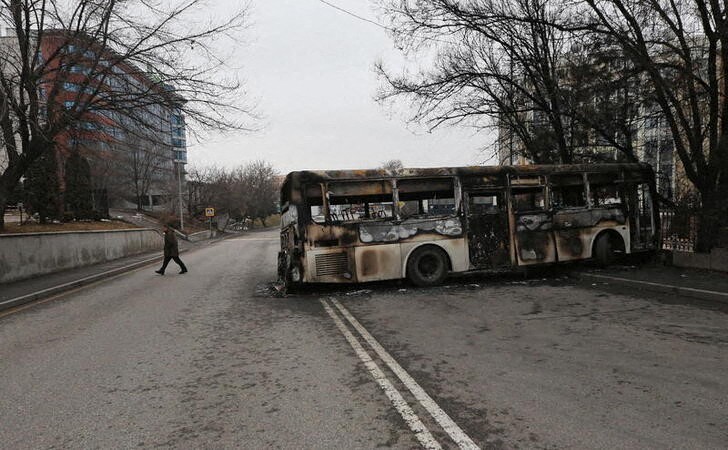 &copy; Reuters. A man walks near a bus, which was burnt during mass protests triggered by fuel price increase, in Almaty, Kazakhstan January 9, 2022. REUTERS/Pavel Mikheyev