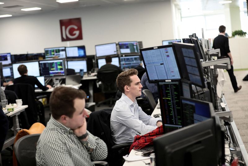 &copy; Reuters. FILE PHOTO: Traders look at financial information on computer screens on the IG Index trading floor in London, Britain February 6, 2018. REUTERS/Simon Dawson/File Photo