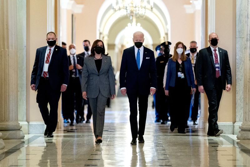 &copy; Reuters. U.S. Vice President Kamala Harris and U.S. President Joe Biden walk through the Hall of Columns on the one-year anniversary of the January 6, 2021 attack on the Capitol in Washington, U.S., January 6, 2022. Stefani Reynolds/Pool via REUTERS