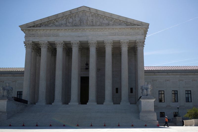 &copy; Reuters. FILE PHOTO: A construction worker walks through the West Front at the United States Supreme Court on Capitol Hill in Washington, U.S., June 24, 2021.  REUTERS/Tom Brenner