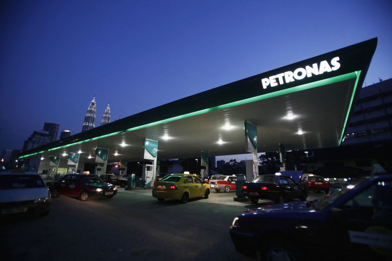 &copy; Reuters. FILE PHOTO: Motorists queue to fill natural gas at a Petronas station with its landmark Petronas Twin Towers headquarters in the background, in Kuala Lumpur February 4, 2012. REUTERS/Bazuki Muhammad