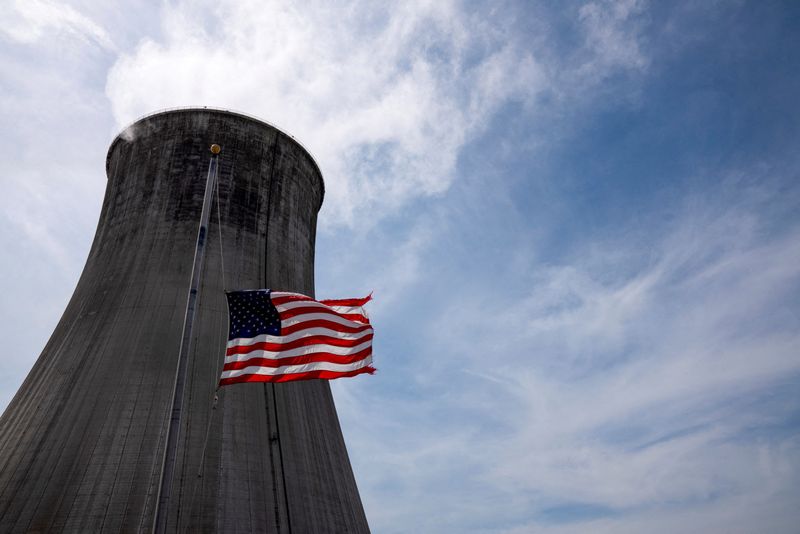 &copy; Reuters. FILE PHOTO: The U.S. flag flies at half mast in front of a coal-fired power plant's cooling tower at Duke Energy's Crystal River Energy Complex in Crystal River, Florida, U.S., March 26, 2021. Picture taken March 26, 2021. REUTERS/Dane Rhys/File Photo