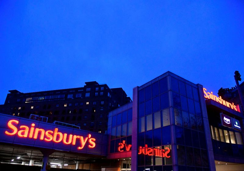 © Reuters. FILE PHOTO: Illuminated signage is seen at a branch of the Sainsbury's supermarket in London, Britain, January 7, 2022. REUTERS/Toby Melville