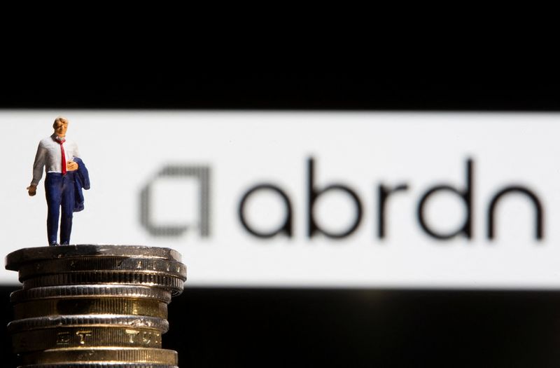 &copy; Reuters. FILE PHOTO: Businessman toy figure is placed on U.K. Pound coins in front of displayed Abrdn logo in this illustration taken, November 8, 2021. REUTERS/Dado Ruvic