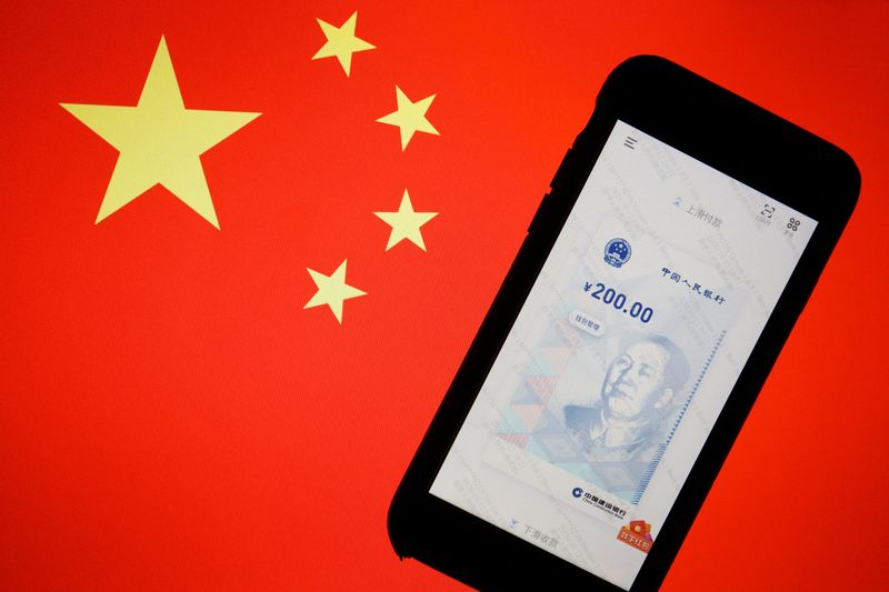 &copy; Reuters. FILE PHOTO: China's official app for digital yuan is seen on a mobile phone placed in front of an image of the Chinese flag, in this illustration picture taken October 16, 2020. REUTERS/Florence Lo/Illustration
