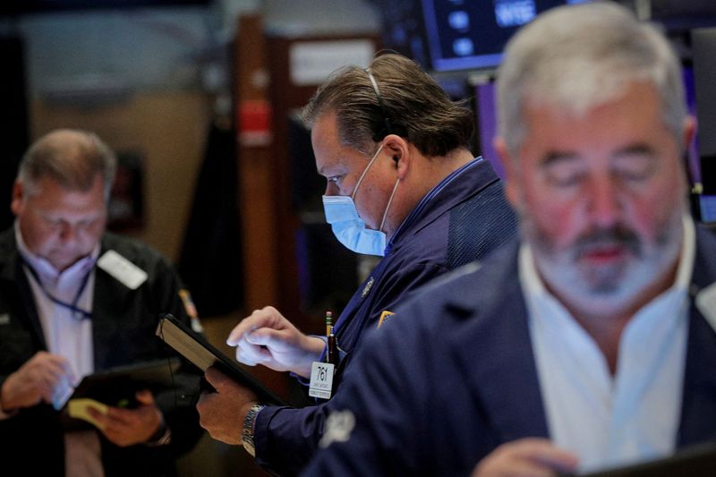 &copy; Reuters. FILE PHOTO: Traders work on the floor of the New York Stock Exchange (NYSE) in New York City, U.S., December 1, 2021.  REUTERS/Brendan McDermid/File Photo