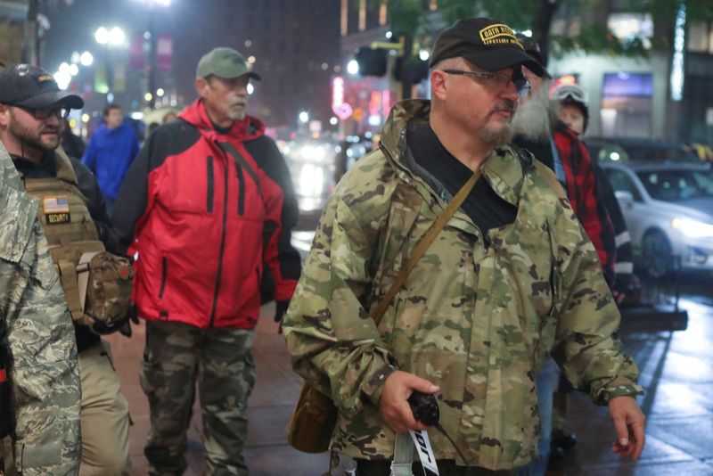 © Reuters. FILE PHOTO: Oath Keepers militia founder Stewart Rhodes holds a radio as he departs with volunteers from a rally held by U.S. President Donald Trump in Minneapolis, Minnesota, U.S. October 10, 2019. Picture taken October 10, 2019.  REUTERS/Jim Urquhart