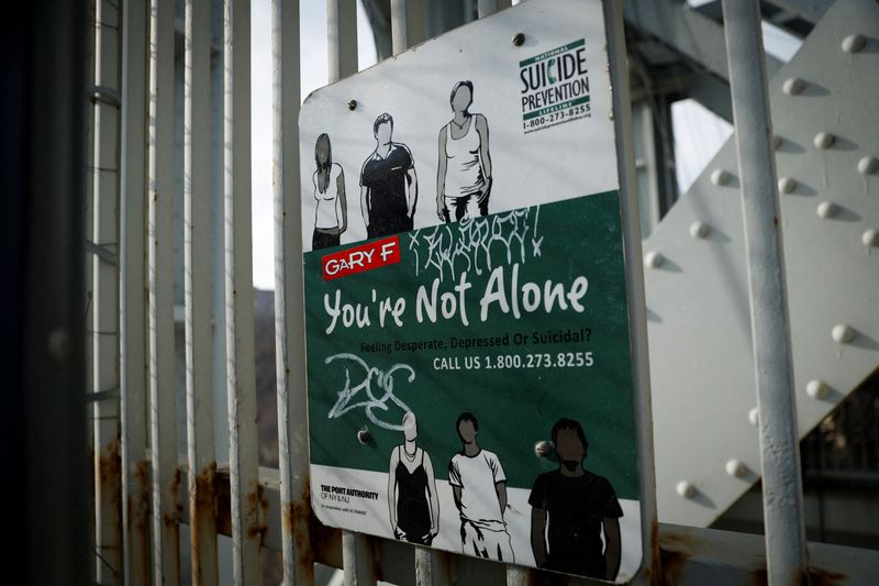 &copy; Reuters. A suicide prevention sign is pictured on a protective fence on the walkway of the George Washington Bridge between New York and New Jersey in New York, U.S., January 12, 2022.  REUTERS/Mike Segar