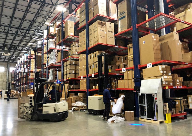 &copy; Reuters. FILE PHOTO: Warehouse workers deal with inventory stacked up to the ceiling at an ABT Electronics Facility in Glenview, Illinois, U.S. December 4, 2018.   REUTERS/Richa Naidu