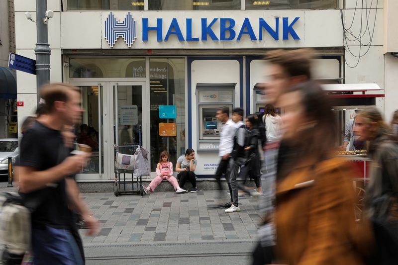 &copy; Reuters. FILE PHOTO: People walk past a branch of Halkbank in central Istanbul, Turkey, October 16, 2019. REUTERS/Huseyin Aldemir/File Photo
