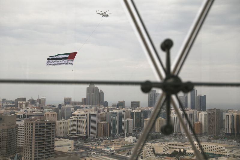 &copy; Reuters. FILE PHOTO: A helicopter flies over the downtown skyline, amid the coronavirus disease (COVID-19) outbreak, as seen from the Cleveland Clinic hospital in Abu Dhabi, United Arab Emirates, April 20, 2020. REUTERS/Christopher Pike
