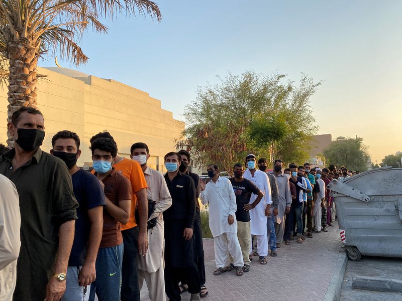 © Reuters. صورة من أرشيف رويترز لرجال يصطفون للحصول على تبرعات في دبي بعد أن فقدوا وظائفهم بسبب فيروس كورونا.
