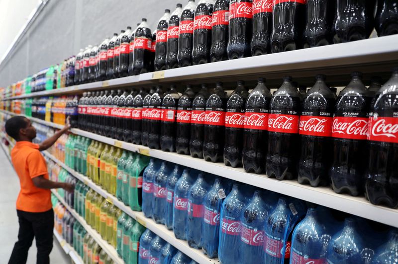 &copy; Reuters. FILE PHOTO: A worker stands next to a shelf with bottles of Coca-Cola at Makro Store Riversands of South African retailer Massmart in Midrand, South Africa, August 28, 2019. REUTERS/Siphiwe Sibeko/File Photo