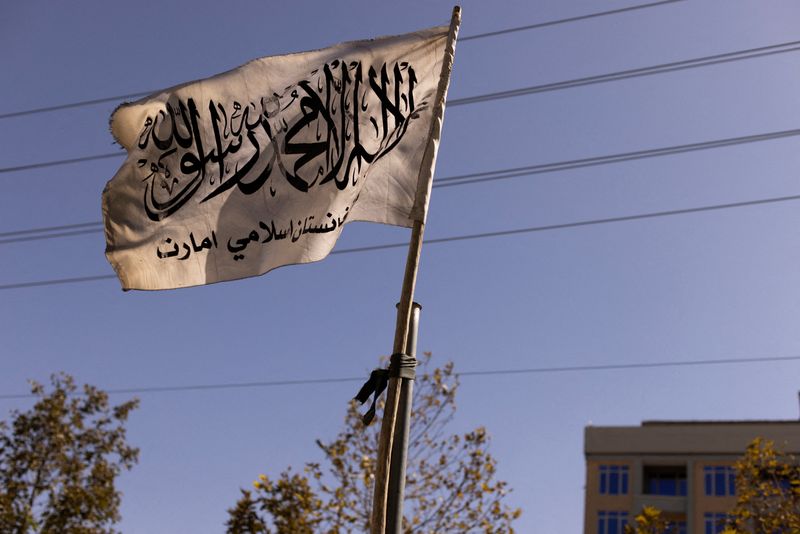 &copy; Reuters. FILE PHOTO: An Islamic Emirate of Afghanistan flag hangs over a street in Kabul, Afghanistan, October 19, 2021. Picture taken October 19, 2021. REUTERS/Jorge Silva