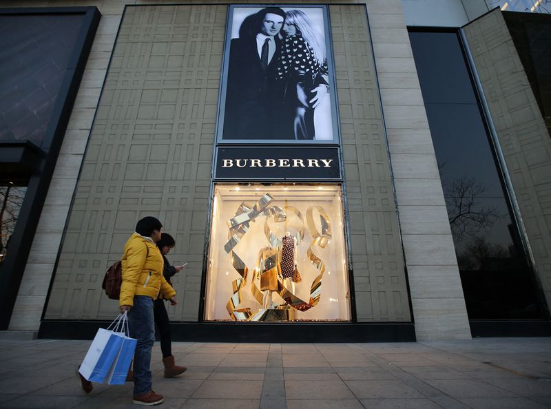 &copy; Reuters. People walk past the window display of a Burberry store in Beijing November 29, 2013. REUTERS/Kim Kyung-Hoon