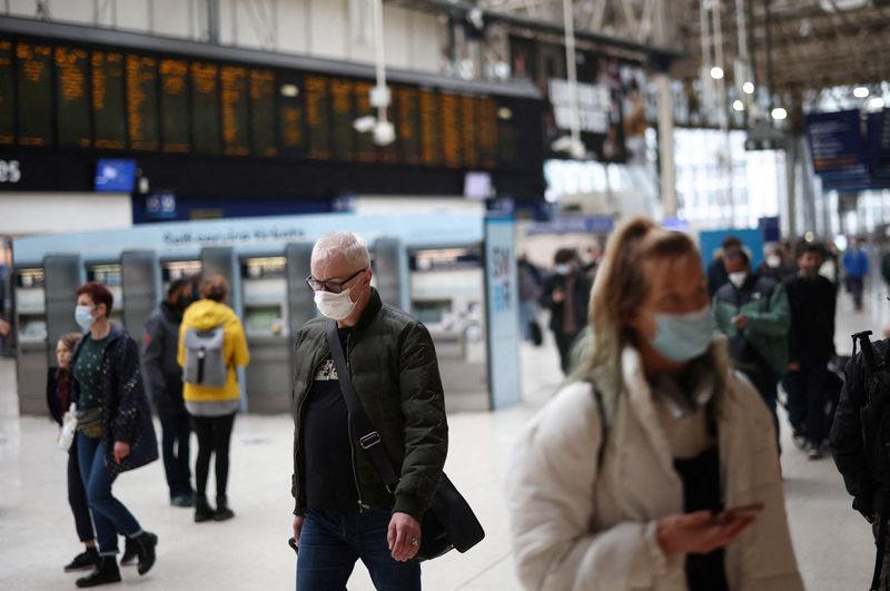 &copy; Reuters. FILE PHOTO: People wearing protective face masks walk through Waterloo train station, amid the coronavirus disease (COVID-19) outbreak, in London, Britain, January 3, 2022. REUTERS/Henry Nicholls