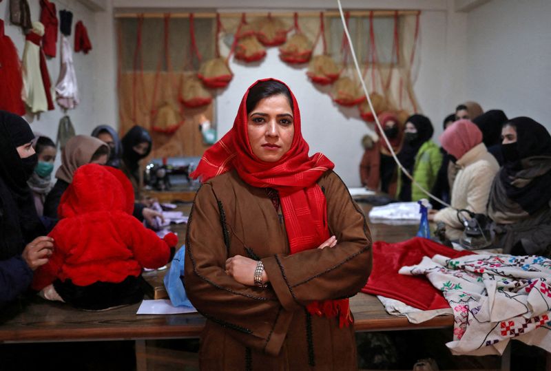 &copy; Reuters. Sohaila Noori, 29, owner of a sewing workshop, poses at her workshop in Kabul, Afghanistan January 15, 2022. REUTERS/Ali Khara