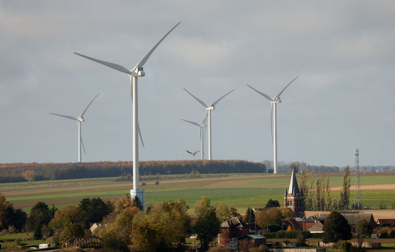 &copy; Reuters. Power-generating windmill turbines are seen behind a church in the village of Inchy-en-Artois, France, November 1, 2021. REUTERS/Pascal Rossignol