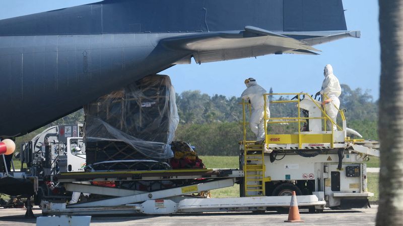 © Reuters. Personnel wearing personal protection equipment (PPE), and a load of humanitarian relief supplies sent by New Zealand are seen next to an aircraft at Fua?amotu International Airport on the island of Tongatapu, Tonga, January 20, 2022 in this picture obtained from social media. New Zealand High Commission, Nuku'alofa Tonga/via REUTERS  THIS IMAGE HAS BEEN SUPPLIED BY A THIRD PARTY MANDATORY CREDIT. NO RESALES. NO ARCHIVES.