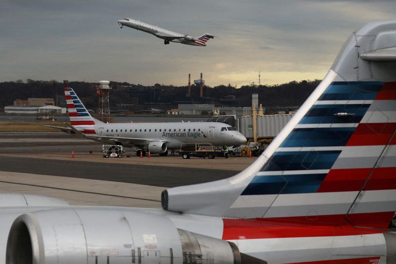 &copy; Reuters. FILE PHOTO: A jet from American Eagle, a regional branch of American Airlines (AA), takes off past other AA aircraft at Ronald Reagan Washington National Airport in Arlington, Virginia, U.S. December 3, 2021. REUTERS/Chris Helgren/File Photo