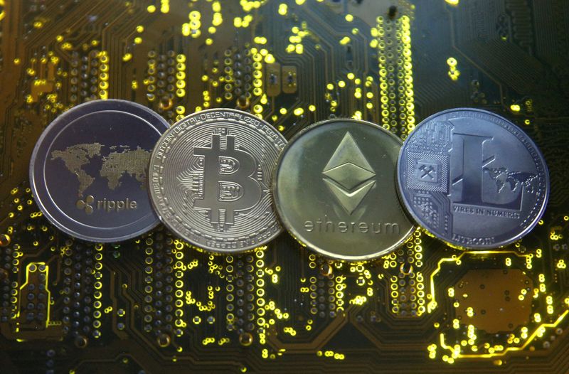 © Reuters. FILE PHOTO: Representations of the Ripple, Bitcoin, Etherum and Litecoin virtual currencies are seen on a PC motherboard in this illustration picture, February 14, 2018. REUTERS/Dado Ruvic/Illustration/File Photo