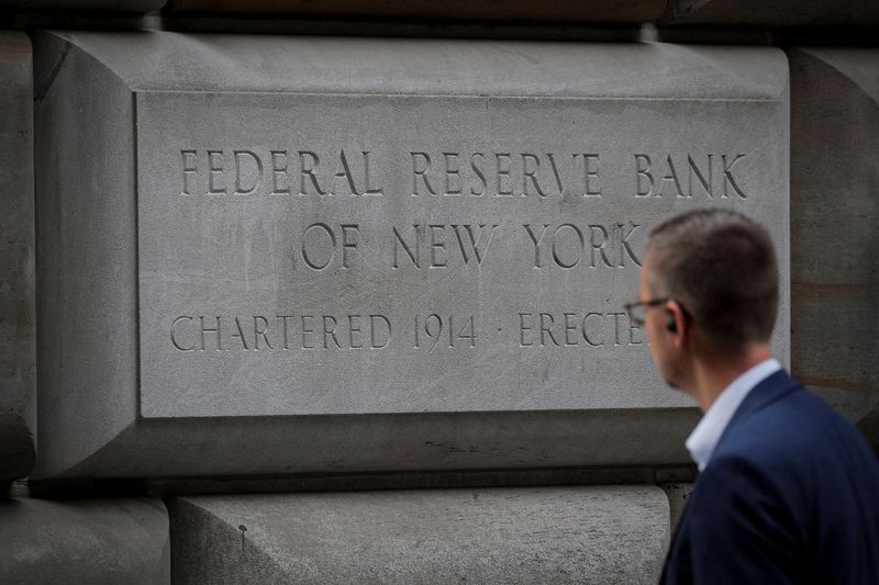 &copy; Reuters. FILE PHOTO: A man walks outside The Federal Reserve Bank of New York in New York City, U.S., October 12, 2021.  REUTERS/Brendan McDermid