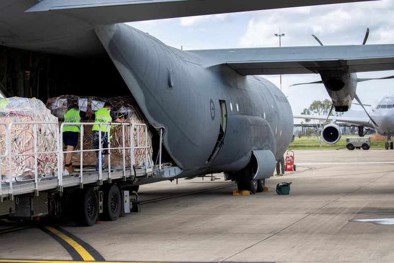 &copy; Reuters. Australian Air Force Air Movement Operators from No. 23 Squadron load humanitarian assistance and supplies onboard a C-130J Hercules aircraft bound for Tonga to assist in relief efforts, at RAAF Base Amberley, Queensland, Australia, January 21, 2022. Aust