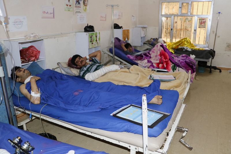 &copy; Reuters. People injured by air strikes on a detention center lie on hospital beds in Saada, Yemen, January 22, 2022. REUTERS/Naif Rahma