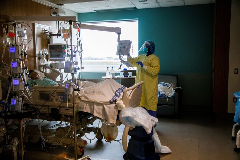 © Reuters. FILE PHOTO: A nurse performs a wellness check of a coronavirus disease (COVID-19) patient inside the intensive care unit of Humber River Hospital in Toronto, Ontario, Canada April 15, 2021. REUTERS/Carlos Osorio