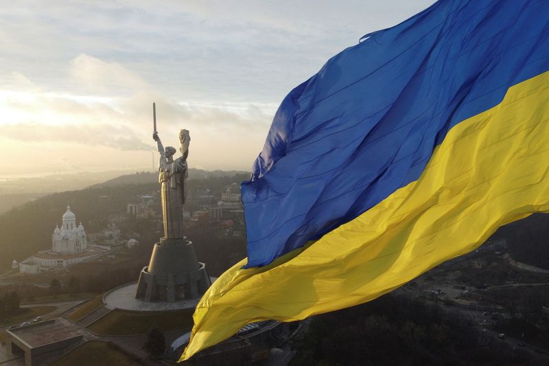 &copy; Reuters. Ukraine's biggest national flag on the country's highest flagpole and the giant 'Motherland' monument are seen at a compound of the World War II museum in Kyiv, Ukraine, December 16, 2021. Picture taken with a drone.  REUTERS/Valentyn Ogirenko