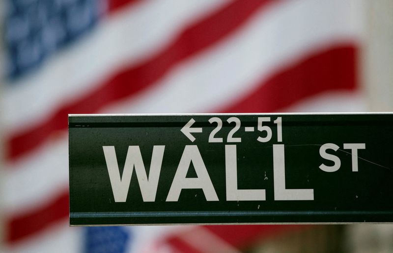 &copy; Reuters. FILE PHOTO: A Wall Street sign hangs on a signpost in front of the New York Stock Exchange August 5, 2011. REUTERS/Lucas Jackson/File Photo