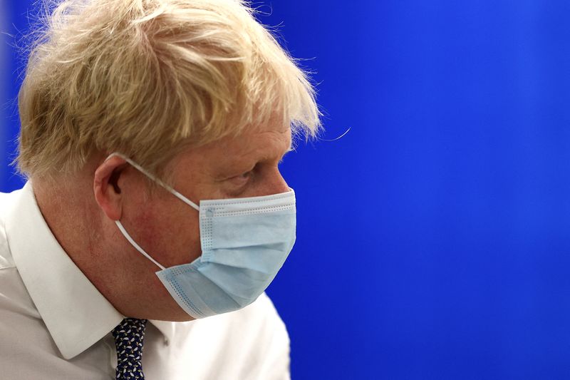 &copy; Reuters. Britain's Prime Minister Boris Johnson wearing a face covering to help mitigate the spread of Covid-19, visits Milton Keynes University Hospital, north of London, Britain January 24, 2022. Adrian Dennis/Pool via REUTERS