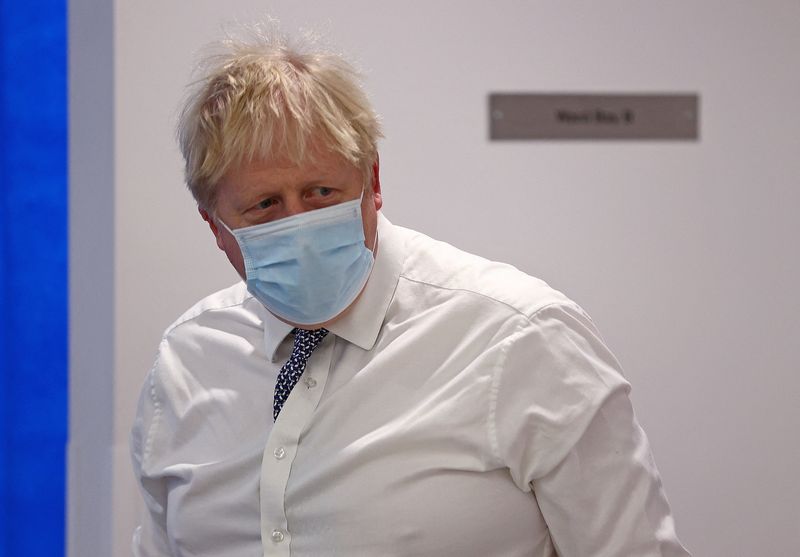 &copy; Reuters. FILE PHOTO: Britain's Prime Minister Boris Johnson wearing a face covering to help mitigate the spread of Covid-19, reacts during his visit to Milton Keynes University Hospital, north of London, Britain January 24, 2022. Adrian Dennis/Pool via REUTERS