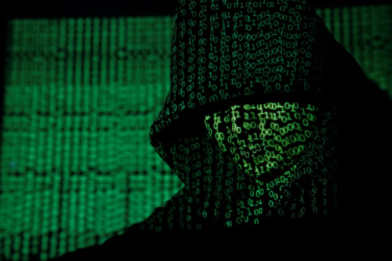 &copy; Reuters. FILE PHOTO: A projection of cyber code on a hooded man is pictured in this illustration picture taken on May 13,  2017. REUTERS/Kacper Pempel/Illustration   
