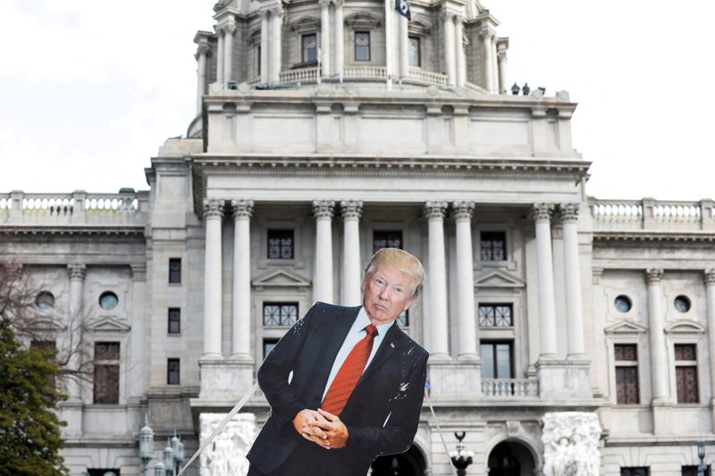 &copy; Reuters. FILE PHOTO: A cardboard cutout depicting U.S. President Donald Trump is seen in front of Pennsylvania State Capitol, as supporters of him are expected to protest against the election of President-elect Joe Biden, outside the Pennsylvania State Capitol in 