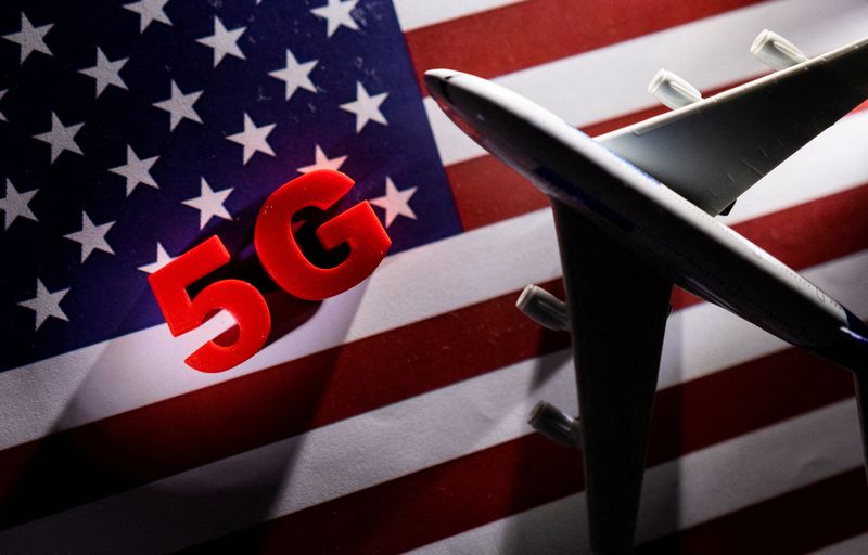&copy; Reuters. FILE PHOTO: 5G words and an airplane toy are placed on a printed U.S. flag in this illustration taken January 18, 2022. REUTERS/Dado Ruvic/Illustration/File Photo