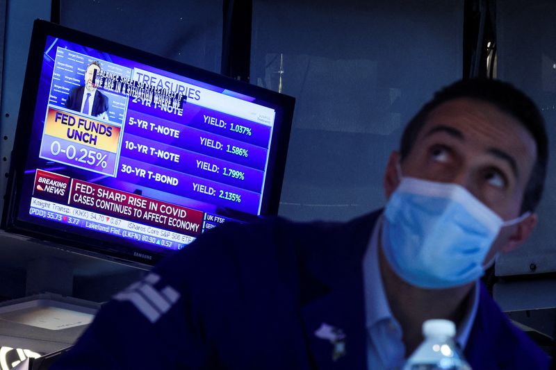 &copy; Reuters. A screen displays the Fed rate announcement as a specialist trader works at his post on the floor of the New York Stock Exchange (NYSE) in New York City, U.S., January 26, 2022.  REUTERS/Brendan McDermid